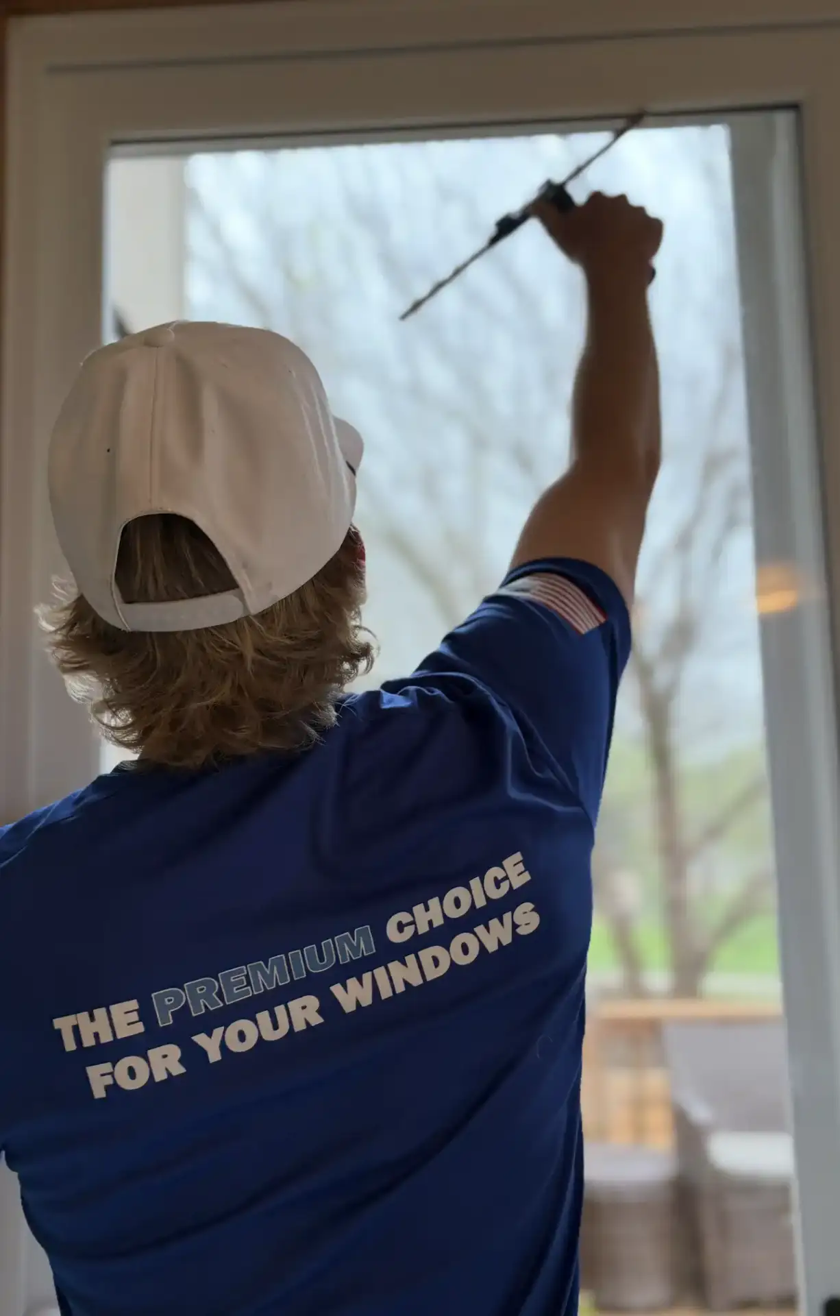 Technician cleaning interior windows of a modern home